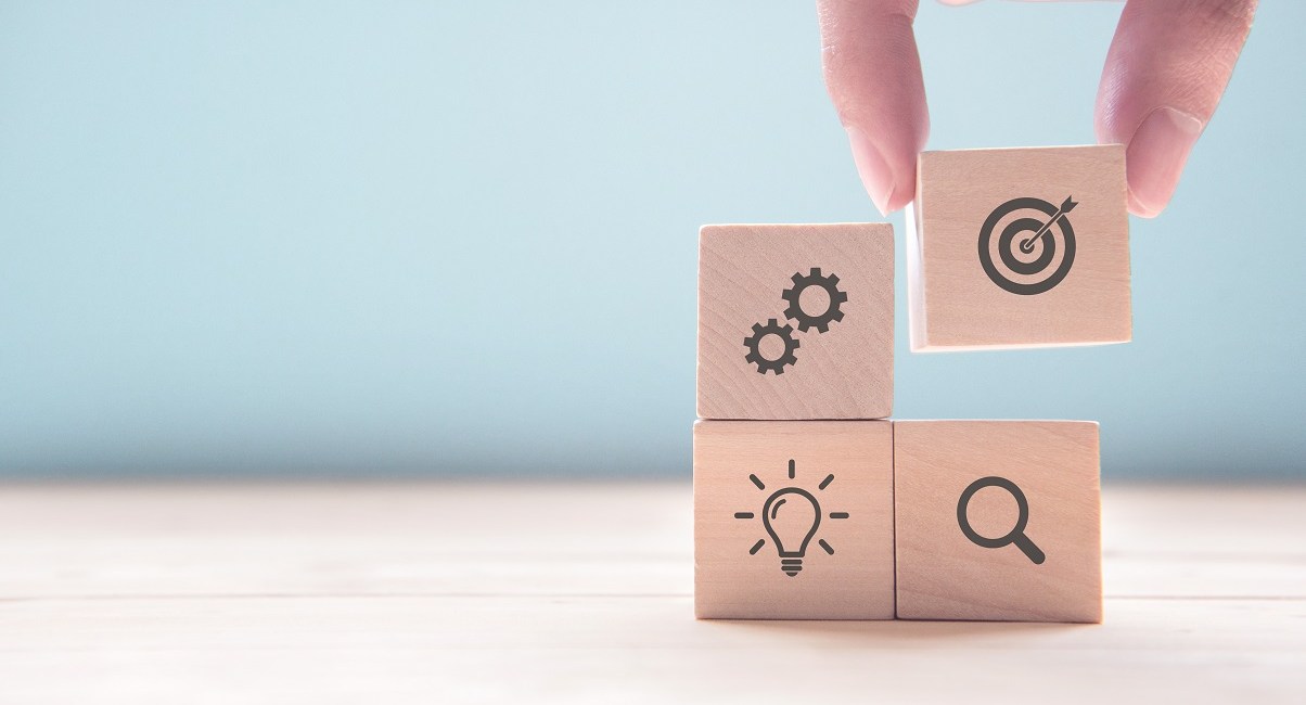 Businessman hand arranging wood block with icon business strategy and Action plan, copy space.